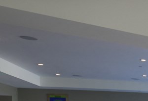 a communal area with tables and chairs in a hotel lobby